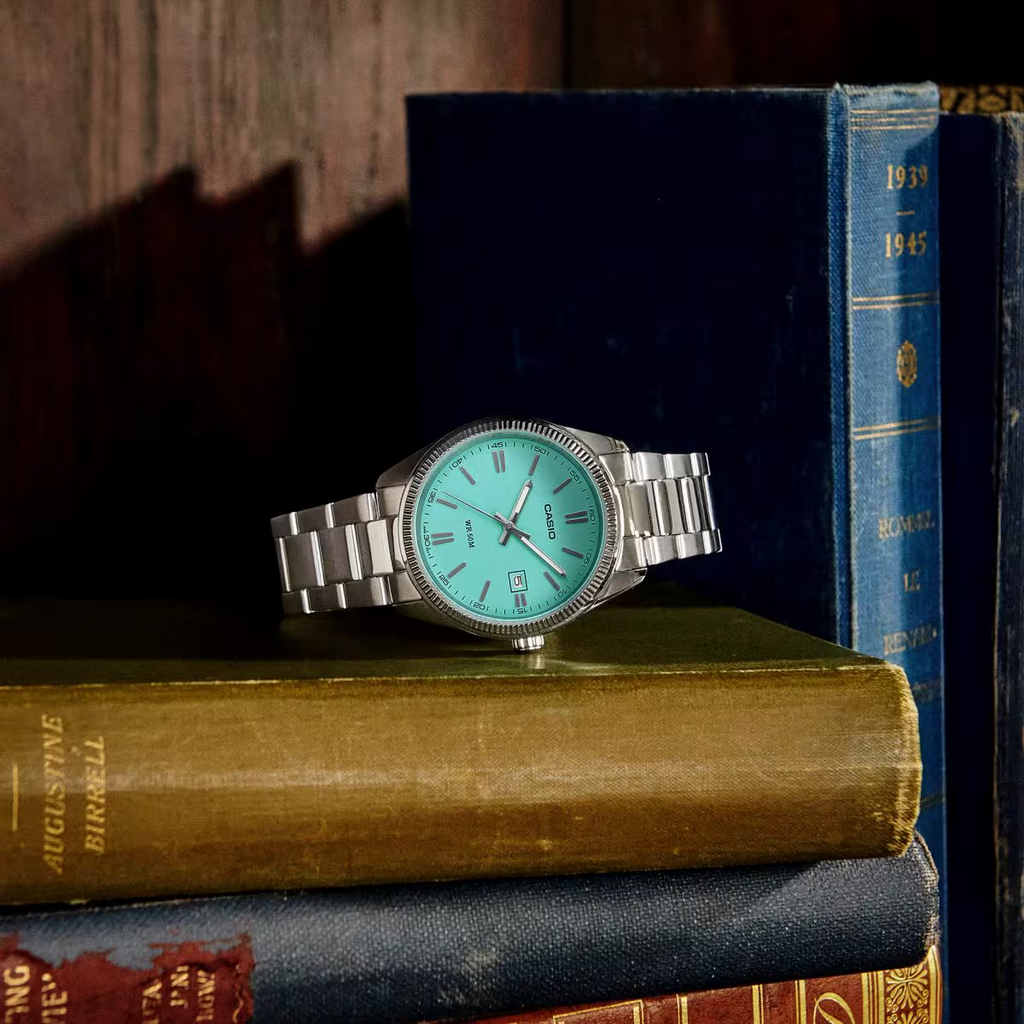 Casio turquoise dial watch styled with vintage books