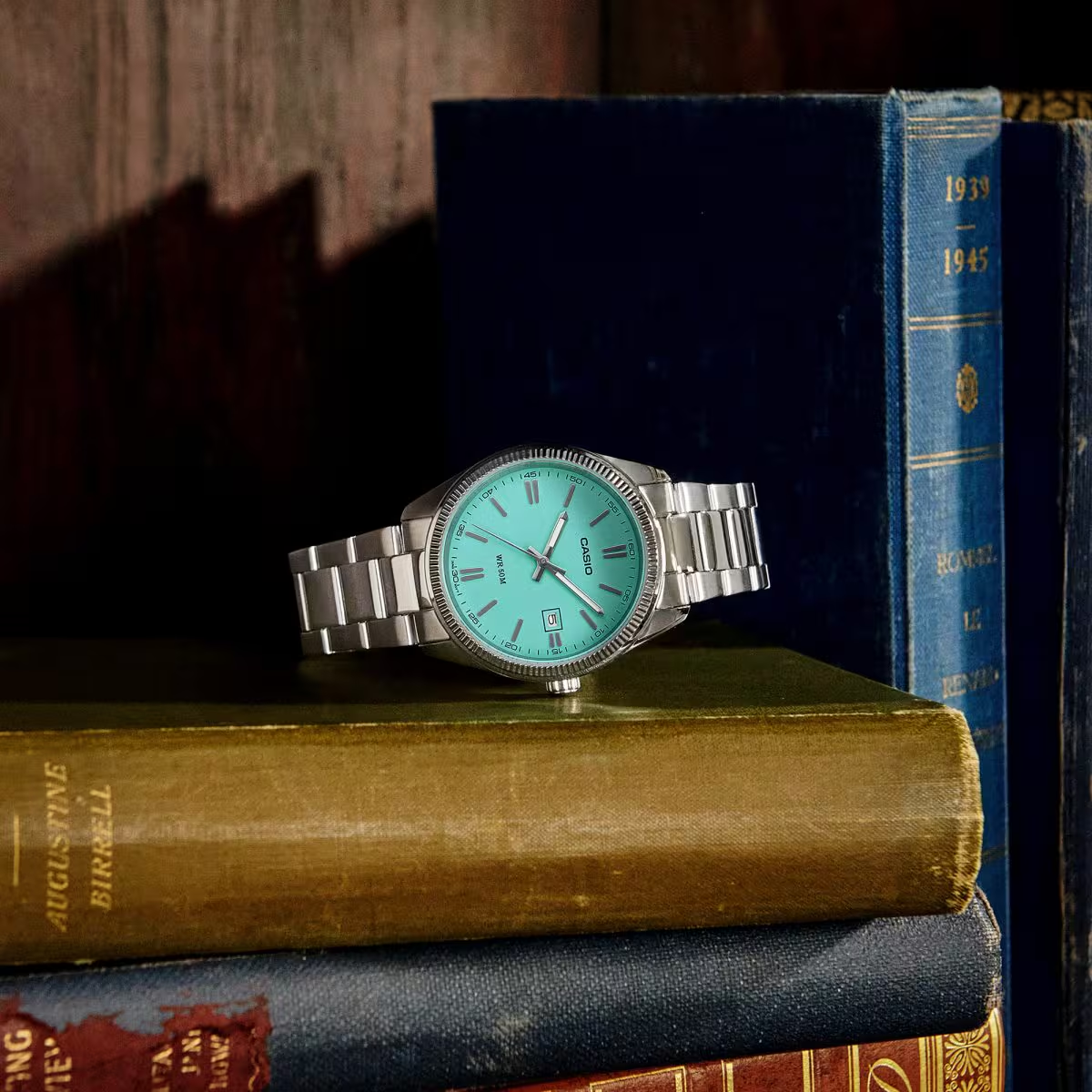 Casio turquoise dial watch styled with vintage books